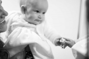 Irene bebé de tres meses fotografia de sus pies y del vestido de bautizo en blanco y negro