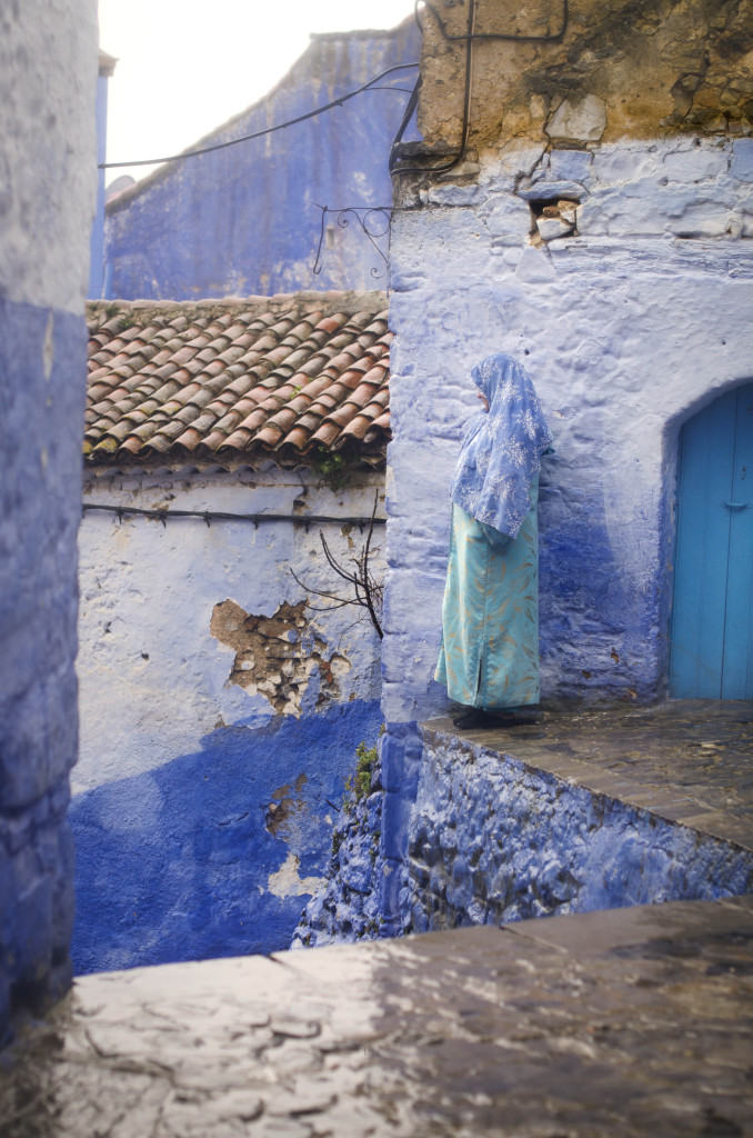 Mujer mirando al infinito entre las calles mojadas de lluvia en Chefchaouen, Marruecos. Fotografía de Milena Martínez, fotógrafa en Madrid